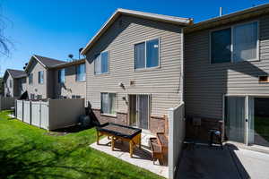 Rear view of property with brick siding, a residential view, and a patio