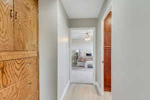 Hall featuring baseboards and light wood-type flooring