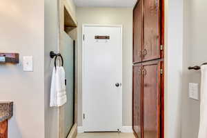 Bathroom featuring a stall shower, vanity, and light wood-style flooring