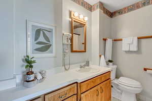 Full bath with vanity, light tile patterned floors, and a shower with shower curtain