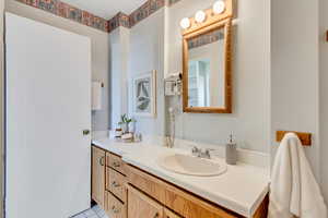Bathroom with vanity and light tile patterned flooring