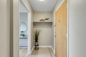 Corridor with light wood finished floors and baseboards
