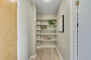 Hallway featuring baseboards and light wood-style floors