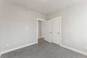 Unfurnished bedroom with baseboards and carpet flooring