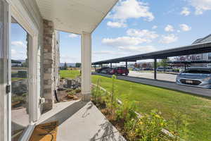 View of green lawn with a porch
