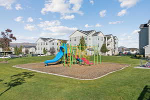 Community jungle gym featuring a yard and a residential view