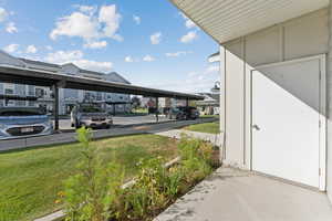 Covered parking lot featuring a residential view