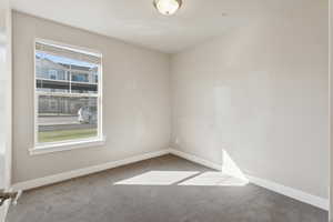 Carpeted spare room with baseboards