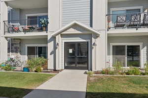 Property entrance with a lawn and french doors