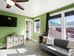 Living area with a mountain view and light colored carpet