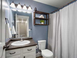 Bathroom with vanity and curtained shower