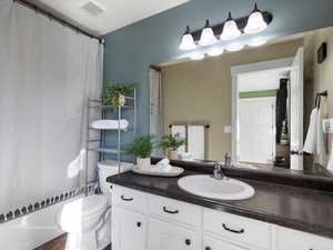 Bathroom featuring shower / tub combo and vanity
