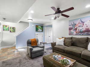 Living area with carpet floors, recessed lighting, and a ceiling fan
