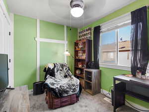 Carpeted bedroom featuring a ceiling fan and baseboards