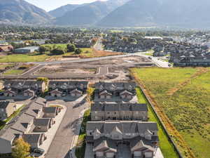 Aerial overview of property's location with nearby suburban area and mountains
