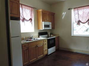 Community Kitchen with white appliances, light countertops, and light cabinetry