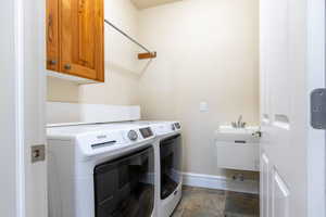 Laundry room with separate washer and dryer, sink and cabinet space