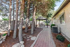 Fenced backyard with a gazebo and a patio area