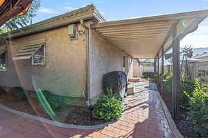 View of side of property featuring stucco siding
