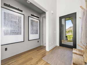 Foyer with light wood-type flooring and baseboards