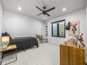 Bedroom with light carpet, a ceiling fan, and recessed lighting