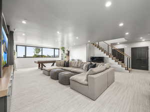 Living area featuring light colored carpet, recessed lighting, billiards table, and stairway