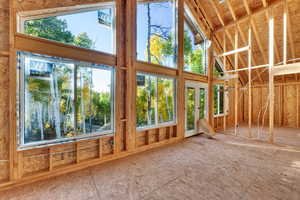 Unfurnished sunroom with vaulted ceiling and french doors