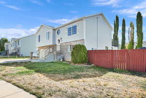 Raised ranch with brick siding and a residential view