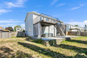 Rear view of house with a patio area, a fenced backyard, stairway, and a wooden deck
