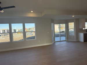Empty room featuring recessed lighting and dark wood-type flooring