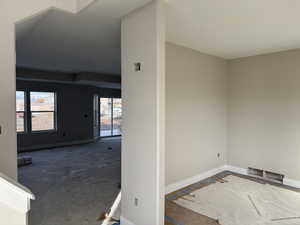 Spare room featuring baseboards and carpet