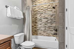 Full bathroom with shower / bath combo and vanity