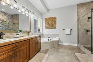 Full bath with a garden tub, a shower stall, and double vanity