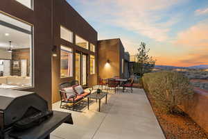Patio terrace at dusk featuring outdoor dining space, stairway, and a patio area