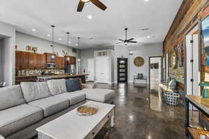 Living area with concrete flooring, ceiling fan, and recessed lighting