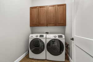 Laundry area with cabinet space and separate washer and dryer