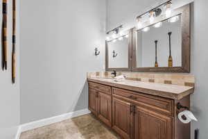 Bathroom featuring vanity and baseboards