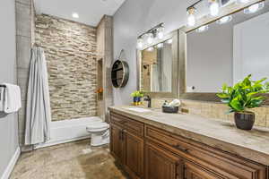 Full bathroom featuring shower / tub combo, vanity, tasteful backsplash, and recessed lighting