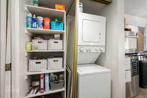 Washroom with stacked washer and clothes dryer