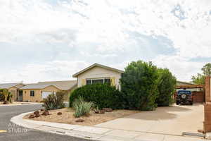View of front of property featuring board and batten siding and concrete driveway