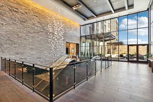 Common area with floor to ceiling windows and a towering ceiling