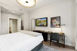 Bedroom featuring wood finished floors and baseboards