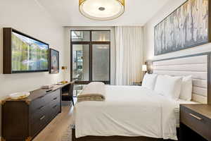 Bedroom featuring light wood finished floors and a desk