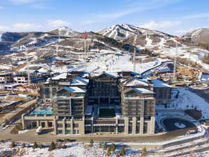 Snowy aerial view featuring a mountain view