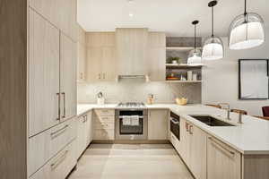 Kitchen with light brown cabinets, modern cabinets, and decorative backsplash