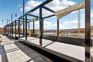 View of patio / terrace featuring a water and mountain view