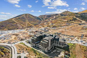 Aerial view of property's location featuring a mountainous background