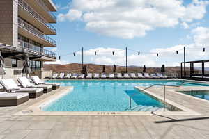 Community pool with a patio area, a mountain view, and a balcony