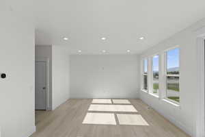 Empty room featuring recessed lighting and light wood-style floors