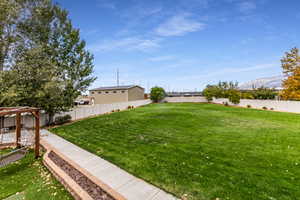 Fenced backyard featuring a mountain view